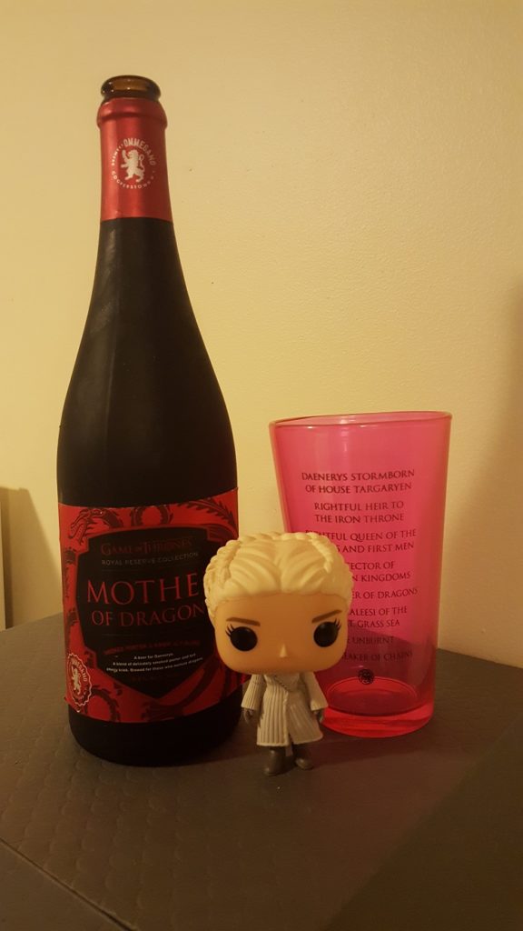 A bottle of "Mother of Dragons" with a Daenerys Targaryen Funko and glass, courtesy of HBO and Brewery Ommegang