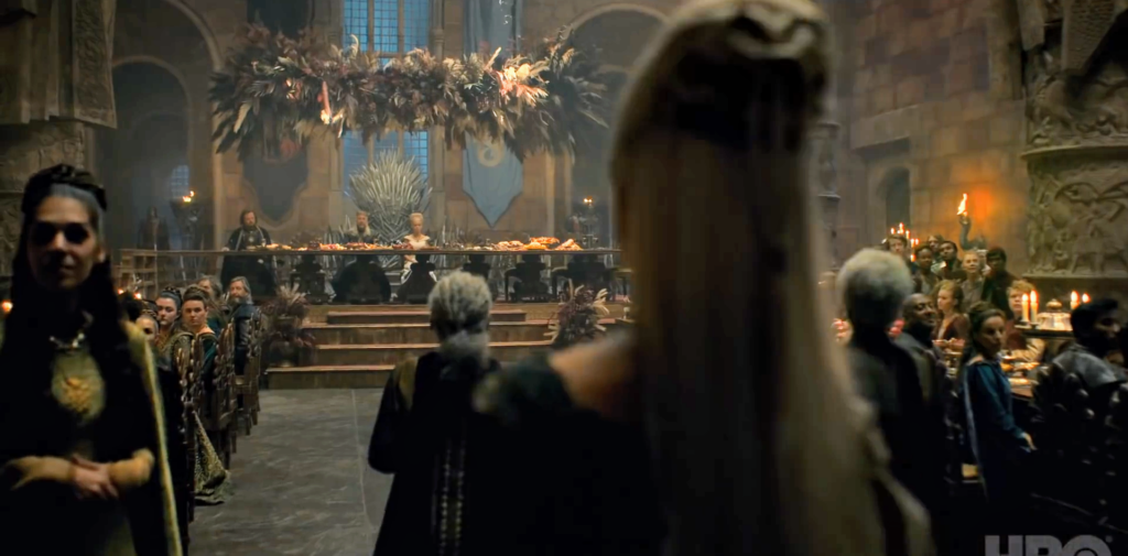 Steve Toussaint's Corlys, Eve Best's Rhaenys, Theo Nate's Laenor and their entire Velaryon ensemble enter the throne room
