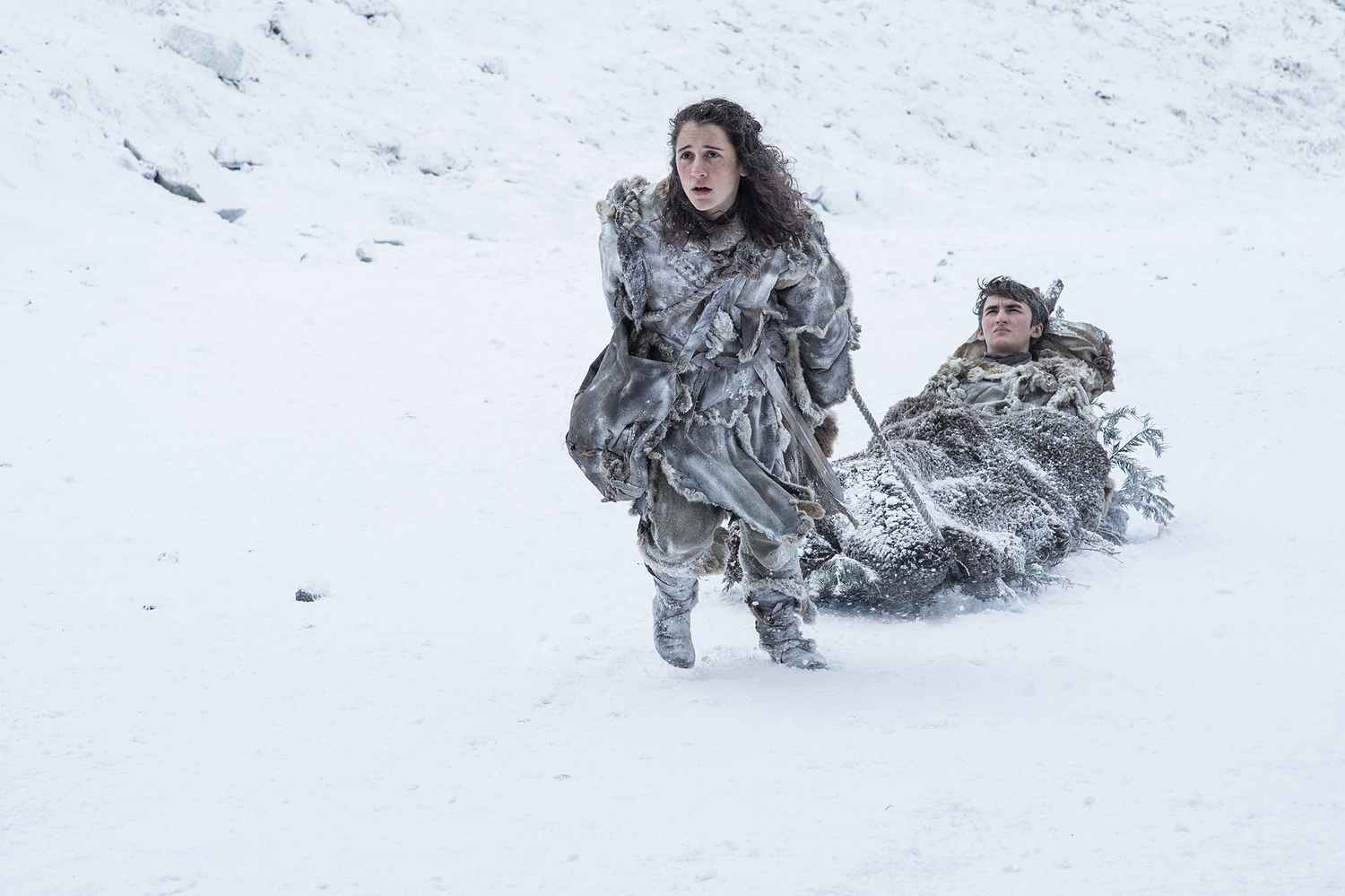 Meera Reed (Ellie Kendrick) carrying Bran Stark (Isaac Hempstead Wright) near the Wall / Photo: Helen Sloan/HBO